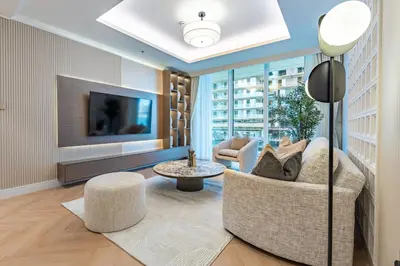 a living room with a couch and a tv at Prime 1 Bedroom with Private Beach in Beachfront in Dubai