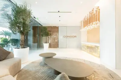 a living room with a bench and a table at Silkhaus Luxury 1BR at Marina Star in Dubai Marina in Dubai