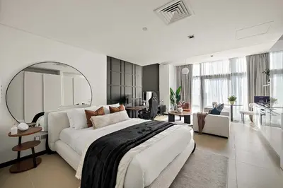 a bedroom with a large bed and a living room at Silkhaus Gamer's Dream Studio in Liberty House in Dubai