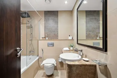 a bathroom with a sink and a toilet and a shower at Silkhaus Gamer's Dream Studio in Liberty House in Dubai