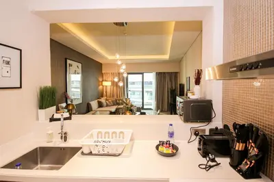 a kitchen with a sink and a large mirror at Stay in Style at Paramount Towers Spacious 1BR High Floor Luxury Furniture Branded Amenties in Dubai