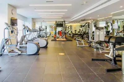 a gym with treadmills and machines in a room at One bedroom Apartment in Dubai Marina next to the Marina Mall in Dubai