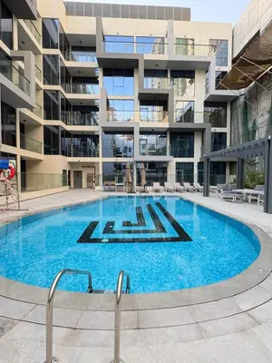 a large swimming pool in front of a building at Spacious 1BR JVC Circle Mall at Your Doorstep in Dubai
