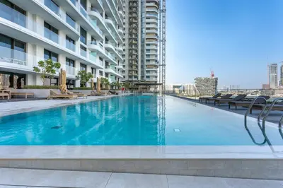 a large swimming pool in the middle of a building at Palace Residence Beach Villa - Direct Beach Access in Dubai