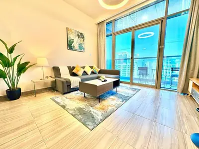 a living room with a couch and a table at The Greendoor - Lake and Sea View, JLT in Dubai