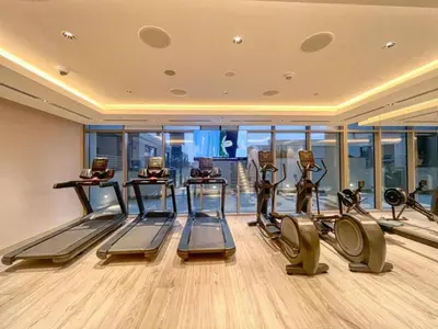 a gym with treadmills and ellipticals in a building at Locations l Elegant One Bedroom l City Views and Free Pool, Gym Access in Dubai