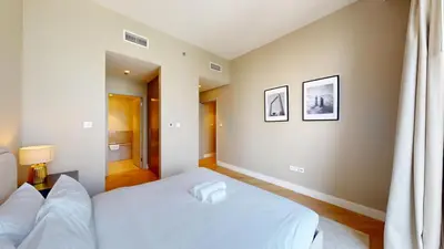a bedroom with two beds with white sheets at Locations l Chic 3 Bedroom l Burj and Fountain Views l Downtown Dubai in Dubai