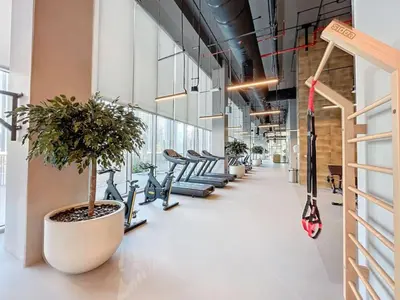 a row of exercise bikes lined up in a hallway at Locations l Chic 3 Bedroom l Burj and Fountain Views l Downtown Dubai in Dubai