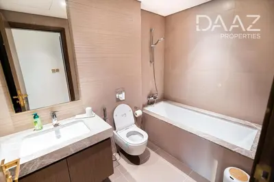 a bathroom with a sink and a toilet and a tub at Branded 2BR in Nakhlat Jumeira - Palm View in Dubai