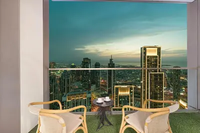 a room with a large window with a table and chairs at Luxury Grande Suites by Hostiva - Full City View in Dubai