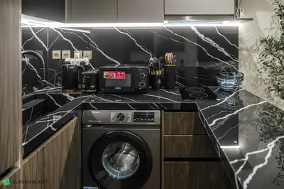 a kitchen with a washer and dryer on a counter at Clever Guest 031 Dubai Gate 2 in Dubai
