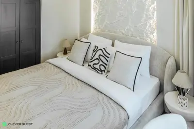 a bedroom with a large bed with white sheets and pillows at Clever Guest 031 Dubai Gate 2 in Dubai