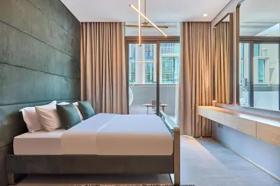 a bedroom with a bed and some windows at Luxury-Comfort & Elegance Studio in Dubai