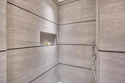 a bathroom with a wall with a mirror at Luxury-Comfort & Elegance Studio in Dubai
