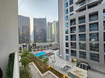 an aerial view of a building with a swimming pool at 2BhK Big Balcony&Canal View Waterfront dubai mall in Dubai