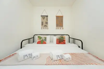a bedroom with a bed with two pillows on it at PVH Stylish Boho 1BR with Study - The Crest in Dubai