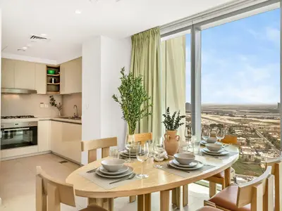 a kitchen and dining room with a table and a large window at Downtown 4BDR Apartment Opposite Dubai Mall, Burj Khalifa Views in Dubai