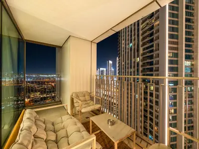 a living room with a couch and a view of a city at Downtown 4BDR Apartment Opposite Dubai Mall, Burj Khalifa Views in Dubai