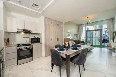 a kitchen and living room with a table and chairs at Burjkhalifa View Top Floor Dubai Mall 7Mins in Dubai