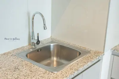 a kitchen sink with a faucet on a counter at Burjkhalifa View Top Floor Dubai Mall 7Mins in Dubai