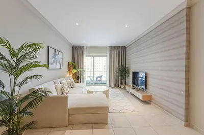 a living room with a couch and a tv at Dubai Marina Marina Heights 2 beds Sleeps 4 in Dubai
