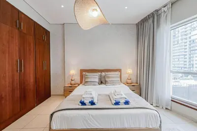 a bedroom with a bed and a large window at Dubai Marina Marina Heights 2 beds Sleeps 4 in Dubai