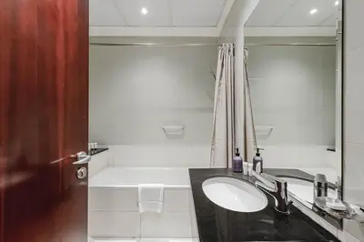 a bathroom with a sink and a bath tub at Dubai Marina Marina Heights 2 beds Sleeps 4 in Dubai
