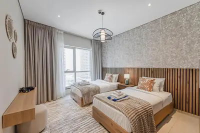 a hotel room with two beds and a couch at Dubai Marina Marina Heights 2 beds Sleeps 4 in Dubai