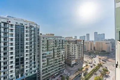 an aerial view of a city with tall buildings at Studio Just Minutes Drive from Miracle Garden, Near Local Parks and Circle Mall, Binghatti Azure, JVC by Deluxe Holiday Homes in Dubai