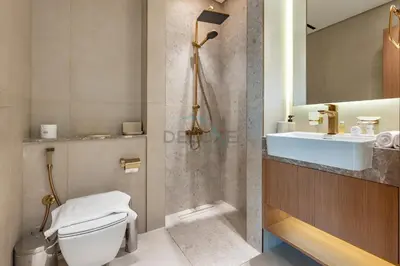 a bathroom with a toilet and a sink at Studio Just Minutes Drive from Miracle Garden, Near Local Parks and Circle Mall, Binghatti Azure, JVC by Deluxe Holiday Homes in Dubai
