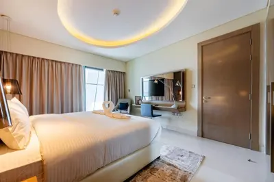 a hotel room with a large bed and a television at TRPS - Paramount Tower D, Business Bay - Premium 1BR Furnished, High Floor, Ready Move In in Dubai