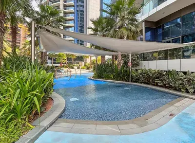 a swimming pool with a canopy over it in a building at TRPS - Paramount Tower D, Business Bay - Premium 1BR Furnished, High Floor, Ready Move In in Dubai