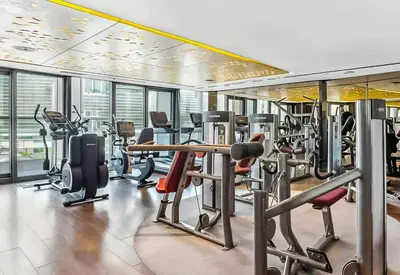 a gym with a lot of treadmills and machines at TRPS - Paramount Tower D, Business Bay - Premium 1BR Furnished, High Floor, Ready Move In in Dubai
