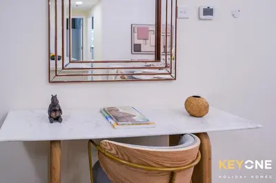 a table with a mirror and a dog sitting on it at Magnificent Two Bedroom Beachfront in Dubai