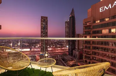a view of a city at night from a building at Luxe 2 Bed with Burj View, 5 Min Walk to Dubai Mall, PS5 by Vista Stays Dubai Downtown in Dubai