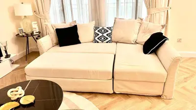 a white couch in a living room with a table at Downtown Dubai Beautiful Upgraded 1-bedroom apartment in Dubai