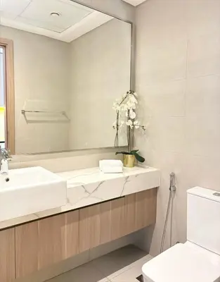 a bathroom with a sink and a mirror at Cozy Studio 15 Min From Burj Khalifa in Dubai
