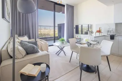 a living room with a couch and a table at Frank Porter - Binghatti Corner in Dubai