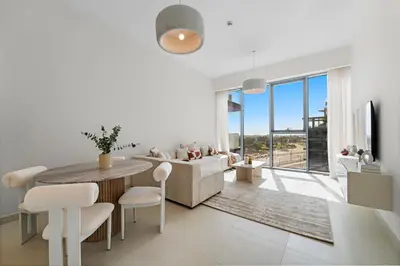 a white living room with a table and chairs at Partial Canal View 2BR plus Maid close to Safa Park in Dubai