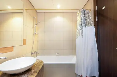 a bathroom with a sink and a bath tub at Fully Furnished Studio Hilliana Tower Sea View and Burj View in Dubai