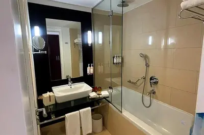 a bathroom with a sink and a shower at Movenpick Apartment JLT in Dubai