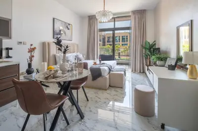 a living room with a table and a couch at Frank Porter - Jwelz Residence in Dubai