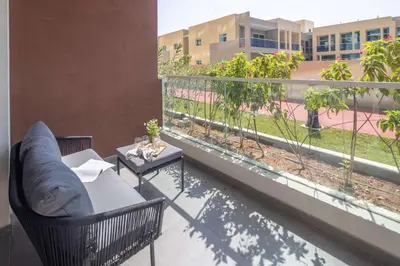 a balcony with two chairs and a table on a building at Frank Porter - Jwelz Residence in Dubai