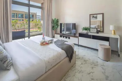 a bedroom with a bed and a large window at Frank Porter - Jwelz Residence in Dubai