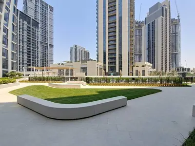 a park in the middle of a city with tall buildings at Vacationer l Chic 2 Bedroom l Prime Location in Creek Harbour l Pool View in Dubai