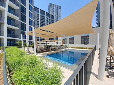 a swimming pool with a canopy over a building at Vacationer l Chic 2 Bedroom l Prime Location in Creek Harbour l Pool View in Dubai