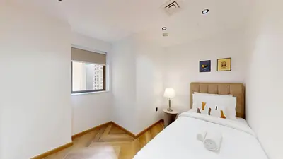 a white bedroom with a bed and a window at Vacationer I Upgraded , Luxury 2 Bedroom Apartment Near JBR Beach, Prime Spot in Dubai