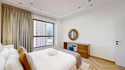 a bedroom with a bed and a large window at Vacationer I Upgraded , Luxury 2 Bedroom Apartment Near JBR Beach, Prime Spot in Dubai