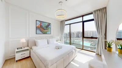 a white bedroom with a large bed and a large window at Palace Residences - Two Bedroom with Creek View in Dubai