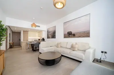 a living room with a couch and a table at Waterfront Living Bright 1 Bedroom Marina in Dubai